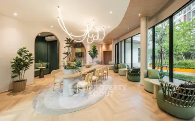 Luxurious modern lobby with elegant seating and lush garden view, perfect for relaxation and social gatherings.