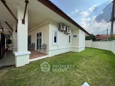 Charming single-story home with spacious lawn and modern exterior design.