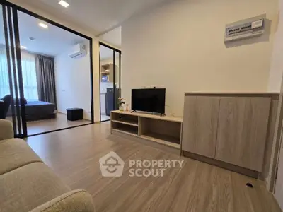 Modern living room with sleek design and open layout, featuring a cozy bedroom view.