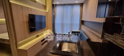 Modern open-layout living room with sleek kitchen and large TV, featuring elegant lighting and floor-to-ceiling windows.