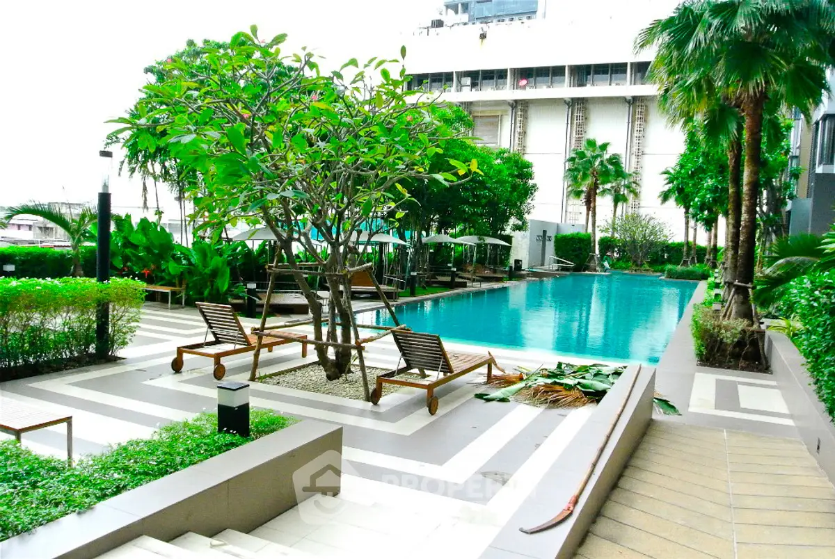 Luxurious outdoor pool area with lush greenery and modern design, perfect for relaxation and leisure.
