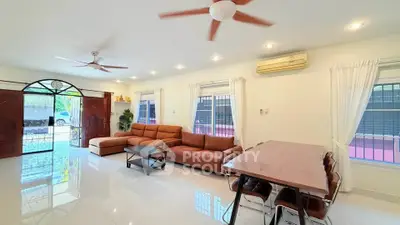 Spacious living room with modern furniture and natural light, perfect for family gatherings.