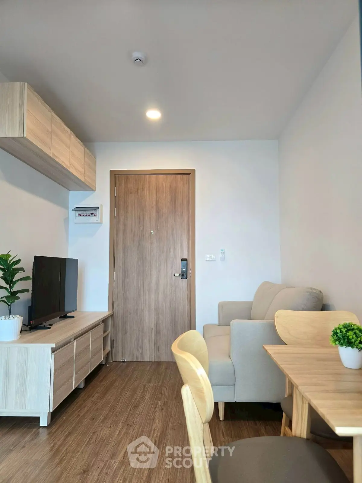 Modern living room with cozy seating and stylish wooden furniture, perfect for relaxation and entertainment.