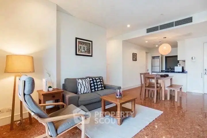 Spacious living room with modern furniture and open kitchen layout in a stylish apartment.