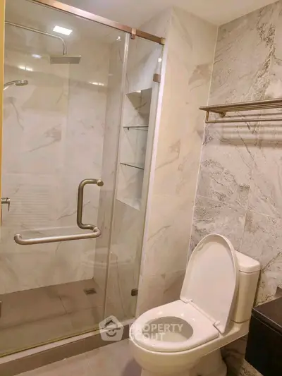Modern bathroom with glass shower and elegant marble tiles