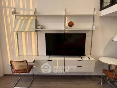 Modern living room with sleek wall-mounted TV unit and stylish furniture