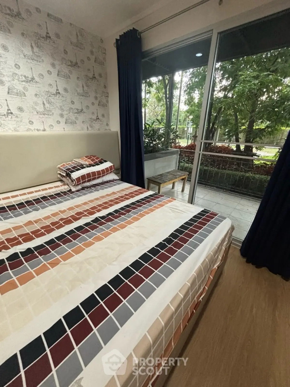 Cozy bedroom with garden view and modern decor in a stylish apartment.