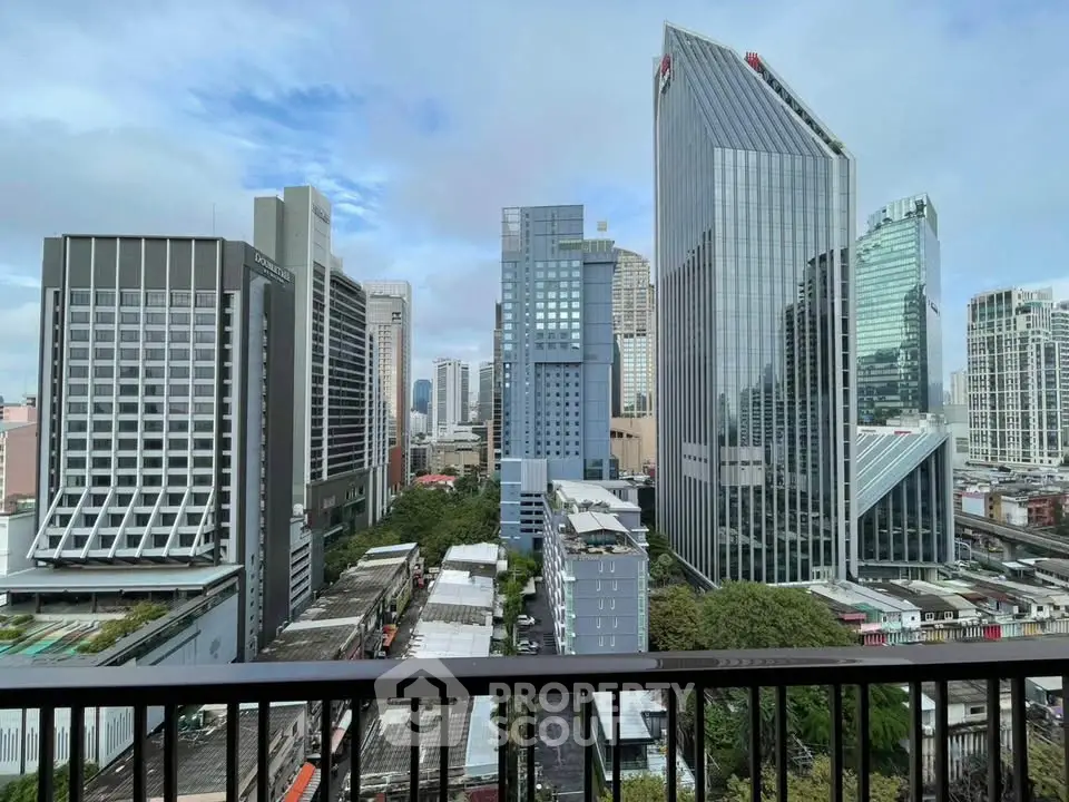 Stunning cityscape view from a high-rise balcony overlooking modern skyscrapers and urban skyline.