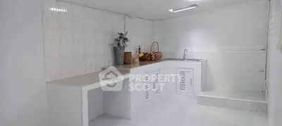 Spacious white kitchen with modern design and ample storage space