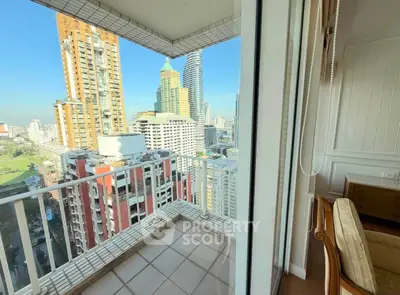 Stunning city view from a high-rise balcony with modern urban skyline.