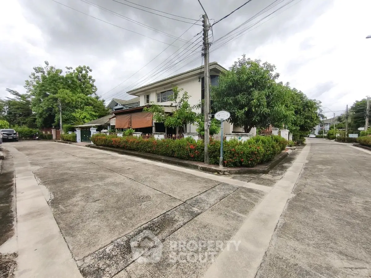 Charming corner house with lush garden and spacious driveway in a serene neighborhood.