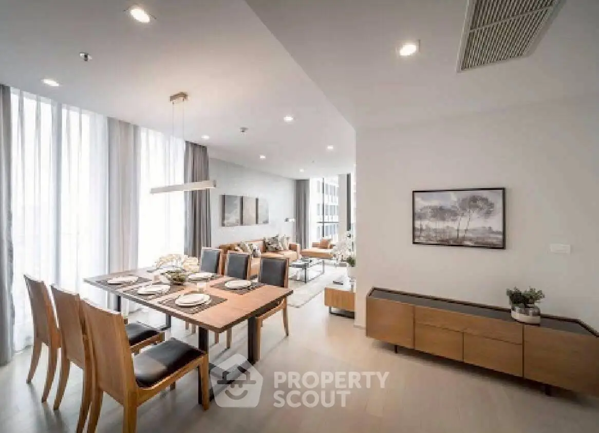 Modern open-plan living and dining area with elegant decor and natural light.