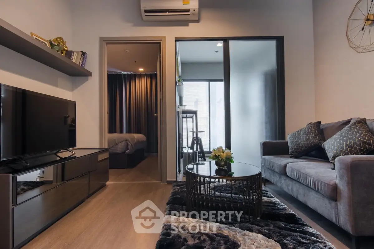 Modern living room with stylish decor and cozy ambiance in a contemporary apartment.