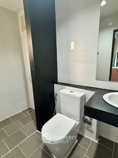 Modern bathroom with sleek design and contemporary fixtures in a stylish real estate property.
