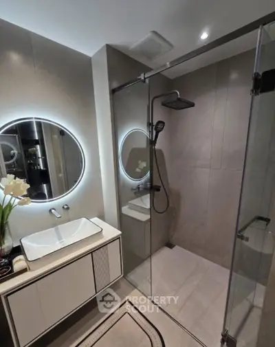 Modern bathroom with sleek shower and illuminated mirror