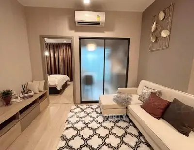 Modern living room with cozy sofa and stylish decor in a contemporary apartment.