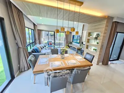 Luxurious open-plan living and dining area with modern decor and large windows.