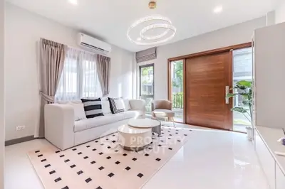 Elegant living room with modern decor, large windows, and stylish lighting in a bright, inviting space.