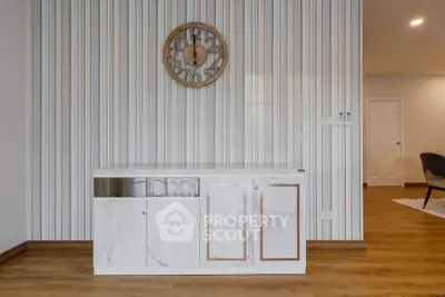 Modern interior with stylish clock and marble cabinet in elegant living space.