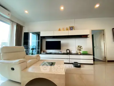 Modern living room with sleek furniture and entertainment center