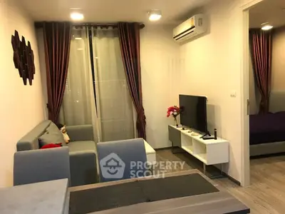 Modern living room with cozy seating and stylish decor in a contemporary apartment.