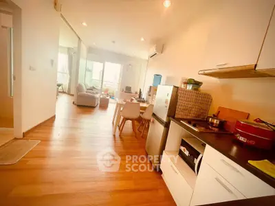 Spacious open-plan kitchen and living area with modern appliances and wooden flooring.