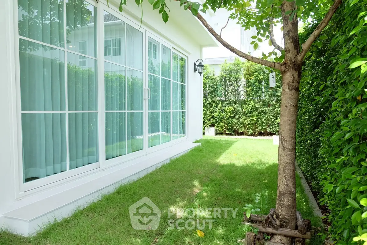 Charming garden view with lush greenery and modern sliding glass doors