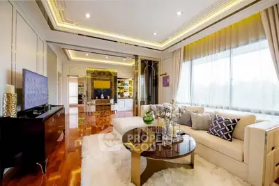 Luxurious living room with elegant decor and large windows offering natural light.