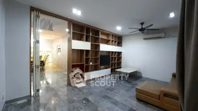 Spacious living room with modern shelving and cozy seating area