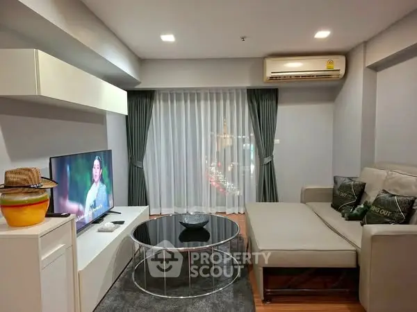 Modern living room with sleek furniture and large window view