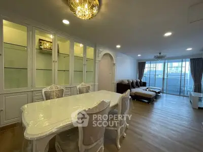 Elegant living room with dining area and large windows in a modern apartment