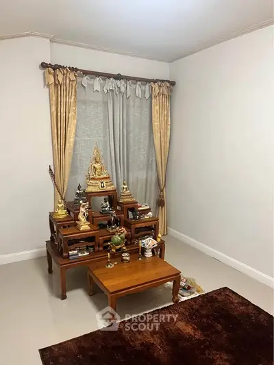 Elegant room with traditional wooden altar and luxurious curtains