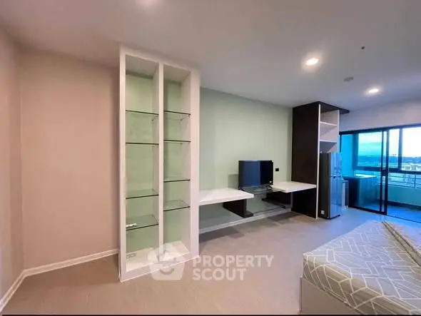 Modern living room with built-in shelves and balcony view in stylish apartment