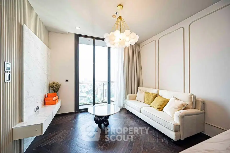 Elegant living room with modern chandelier and city view from large window