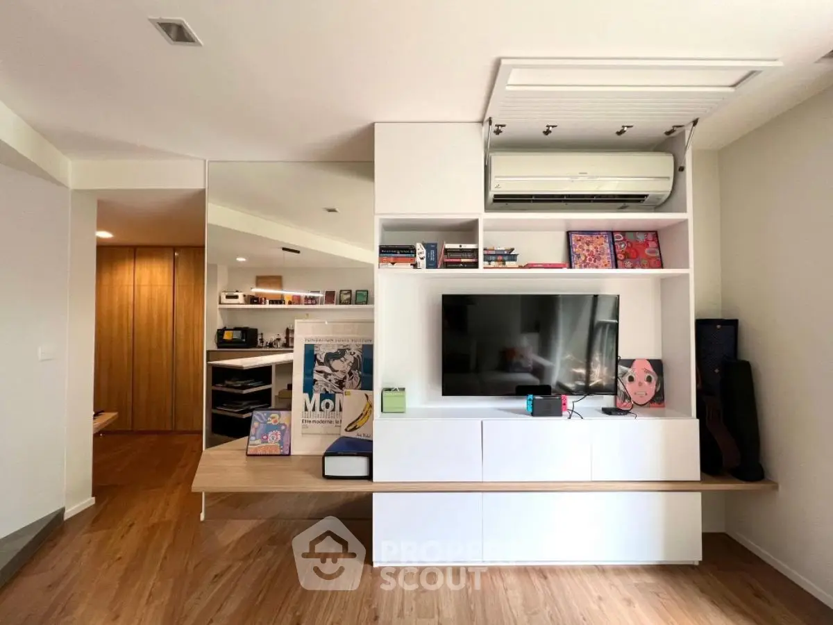 Modern living room with sleek built-in entertainment center and air conditioning unit