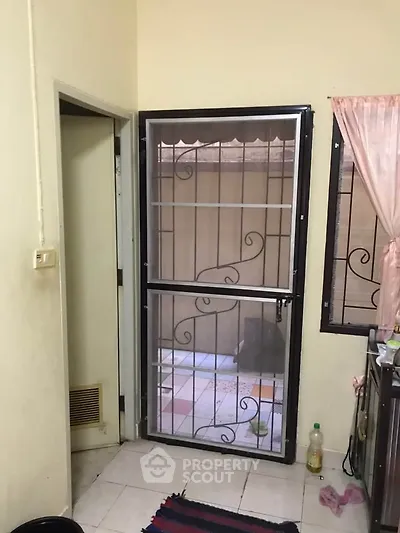 Cozy interior with secure metal door and window, perfect for safety-conscious homeowners.
