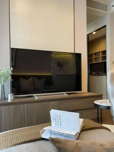 Modern living room with sleek TV and cozy decor, perfect for relaxation and entertainment.