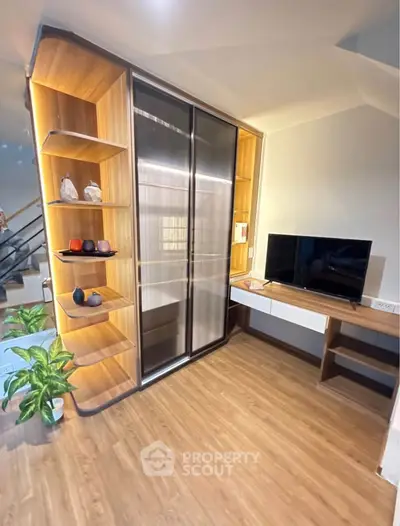 Modern living room with sleek TV unit and stylish shelving