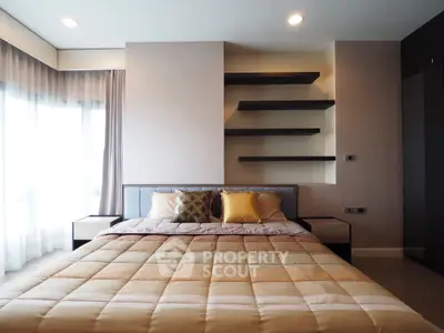Modern bedroom with stylish shelving and cozy bedding in a bright, airy space.