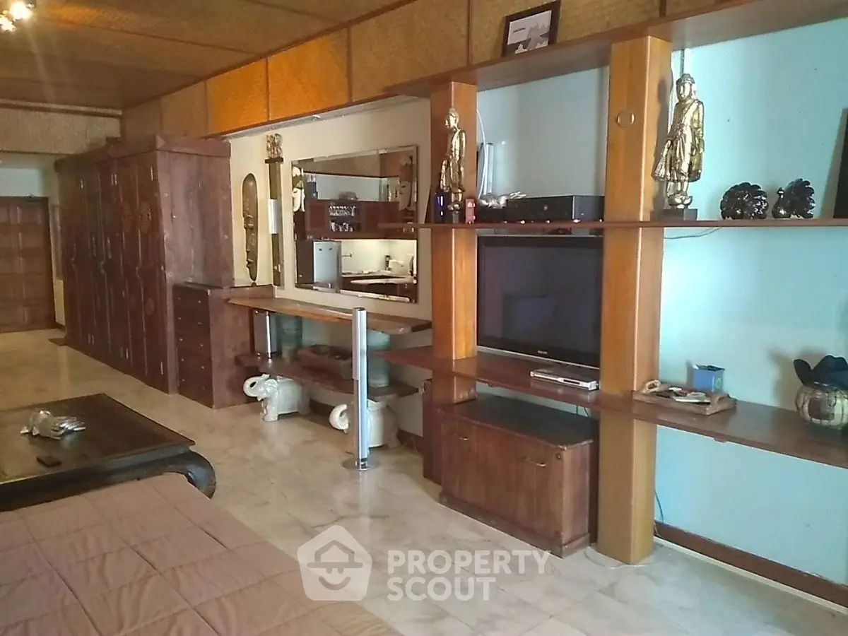 Spacious living room with wooden furniture and built-in entertainment center