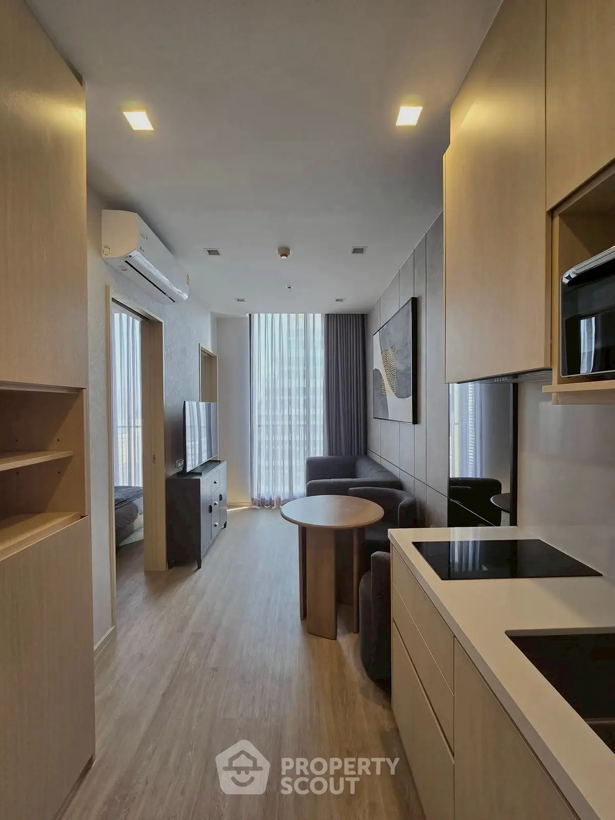 Modern apartment interior with open kitchen and cozy living area