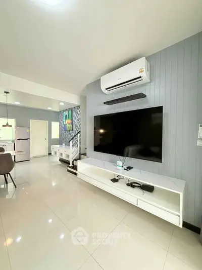 Modern living room with sleek TV setup and air conditioning