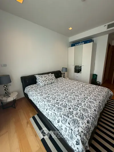 Modern bedroom with stylish decor and ample storage space.