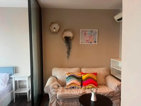 Cozy living room with colorful pillows and modern decor in a stylish apartment.
