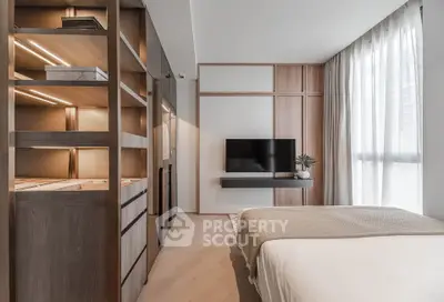 Modern bedroom with sleek design, built-in storage, and wall-mounted TV for luxury living.