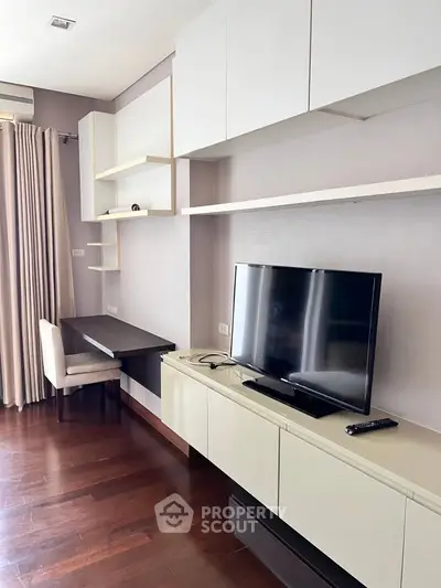 Modern living room with sleek TV unit and study desk, featuring elegant wood flooring and neutral decor.
