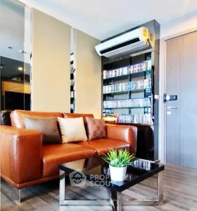 Modern living room with leather sofa, sleek coffee table, and built-in shelving unit.