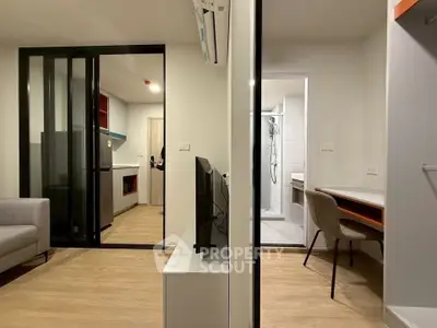 Modern apartment interior with open layout, featuring a cozy living area, sleek kitchen, and stylish bathroom.