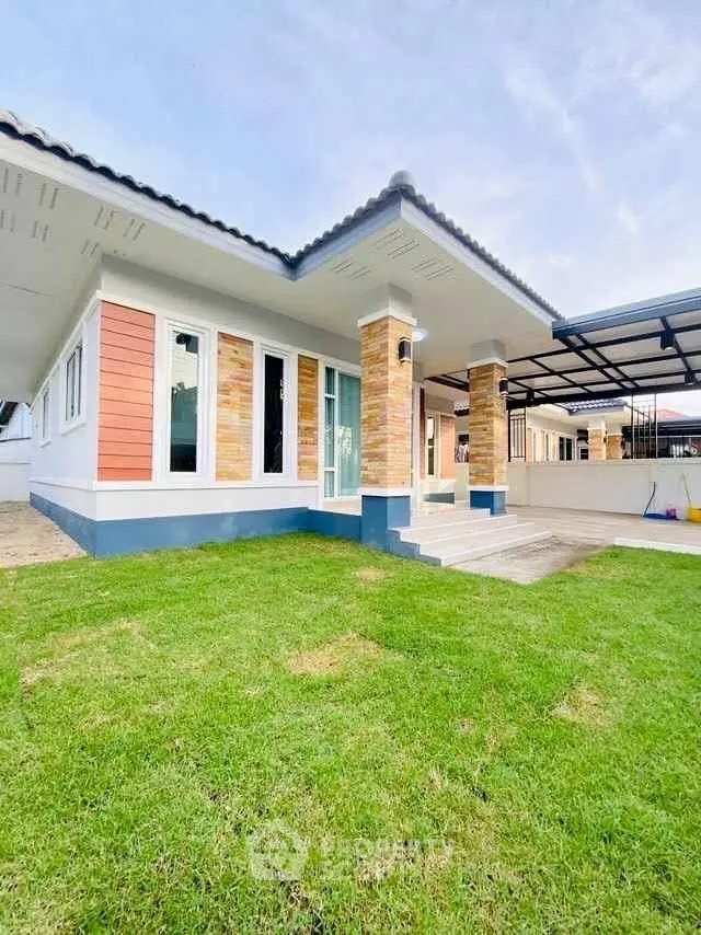 Charming single-story home with modern facade and lush green lawn, perfect for family living.