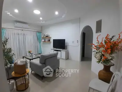 Charming living room with modern decor and cozy seating area, perfect for relaxation and entertainment.